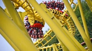 close up of people aboard The Gauntlet with trees in background at Magic Springs in Hot Springs, Arkansas, USA